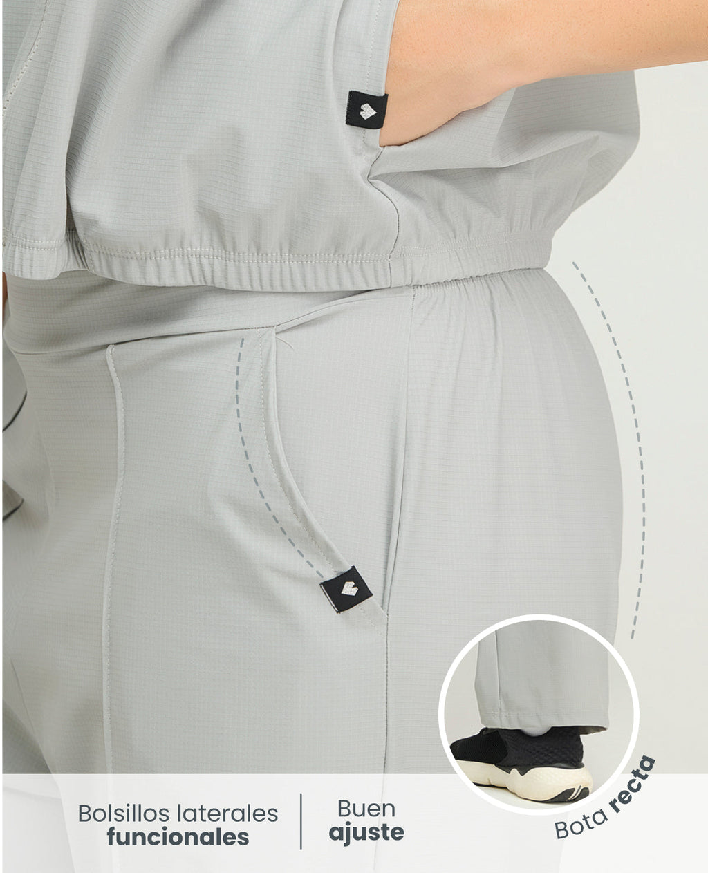 Primer plano de pantalón deportivo gris para mujer con bolsillos laterales, bota recta y cintura elástica ajustable.