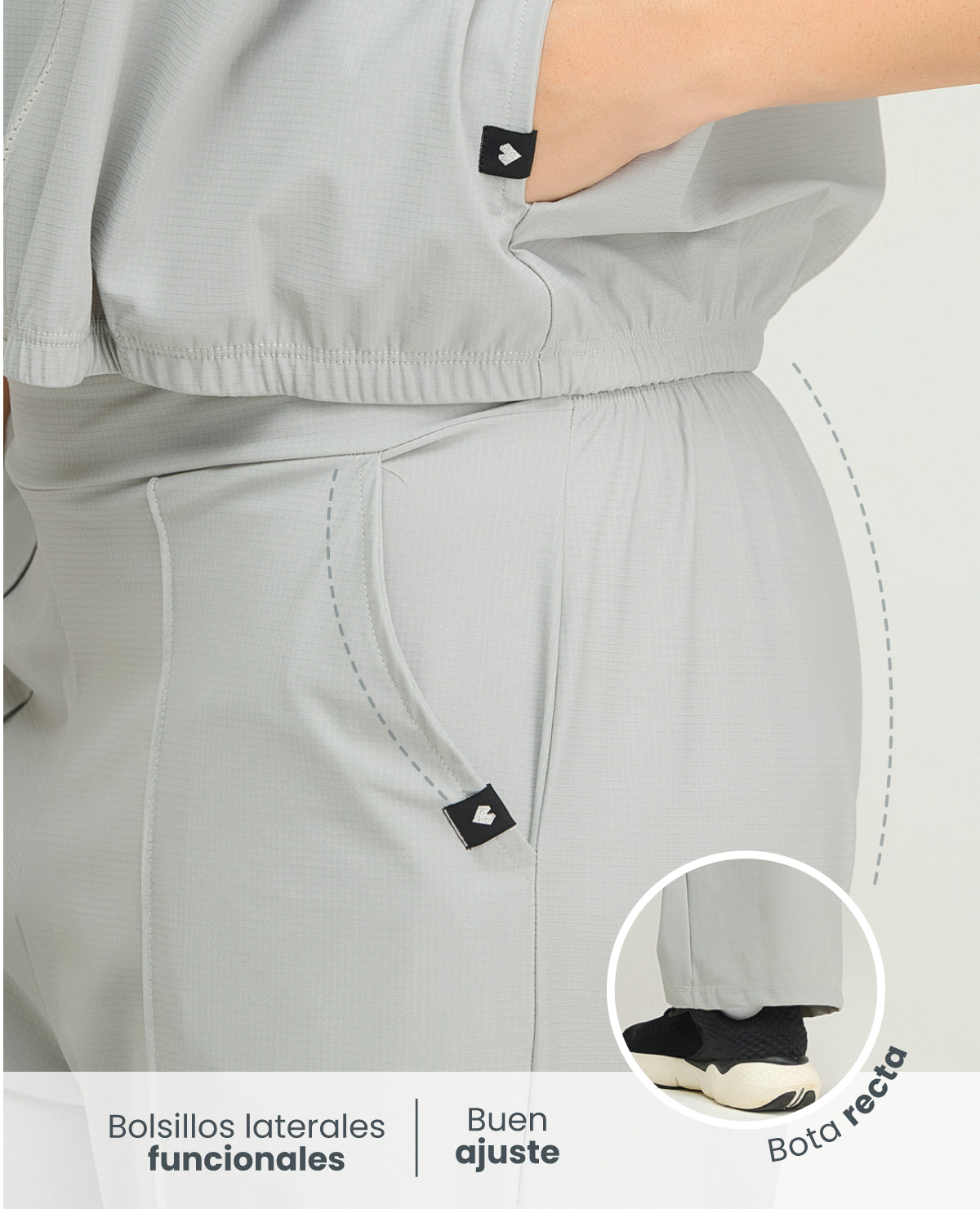 Primer plano de pantalón deportivo gris para mujer con bolsillos laterales, bota recta y cintura elástica ajustable.