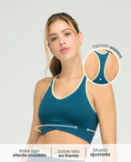 Top deportivo azul con silueta ajustada, base cruzada y espalda atlética para mujer St. Even.