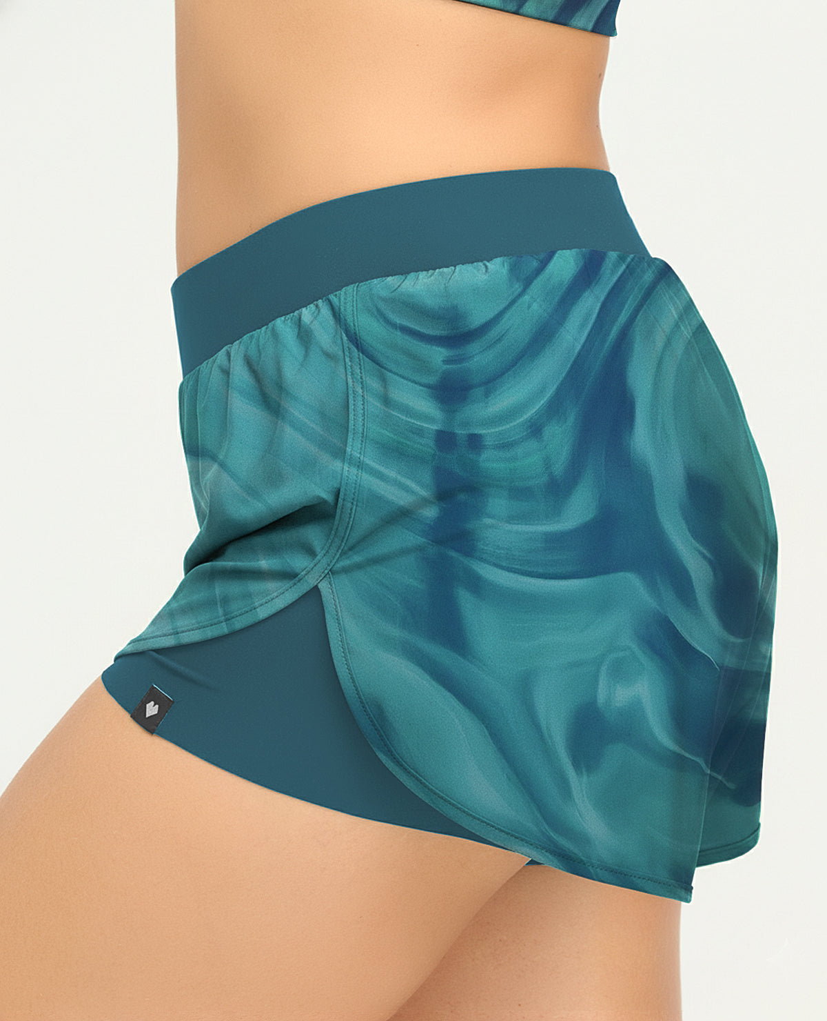 Short deportivo de silueta amplia con estampado azul, cintura elástica y short interno ajustado para mujer.