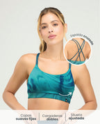 Top deportivo azul con copas fijas, cargaderas dobles y espalda cruzada en silueta ajustada para mujer.