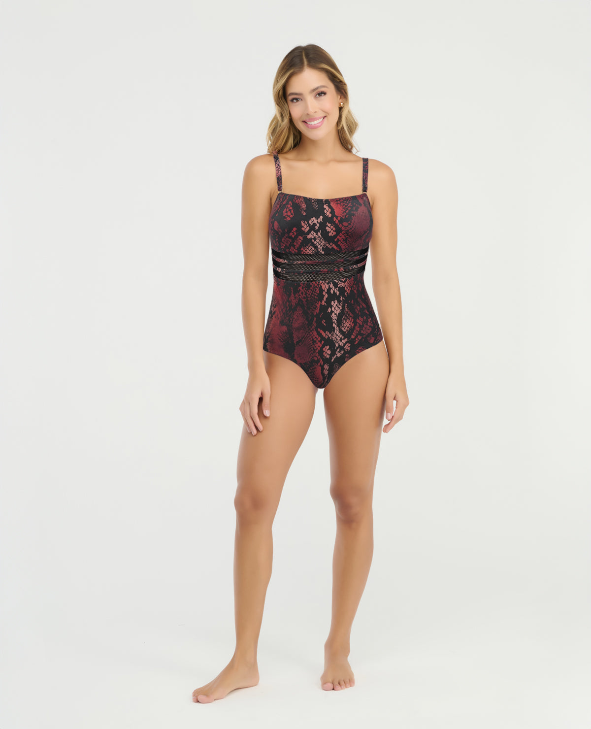 Vestido de baño entero con control de abdomen, estampado animal print rojizo y detalle de malla transparente.
